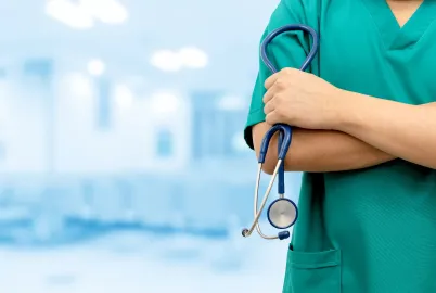 Mulher médica com estetoscópio na mão dentro de hospital